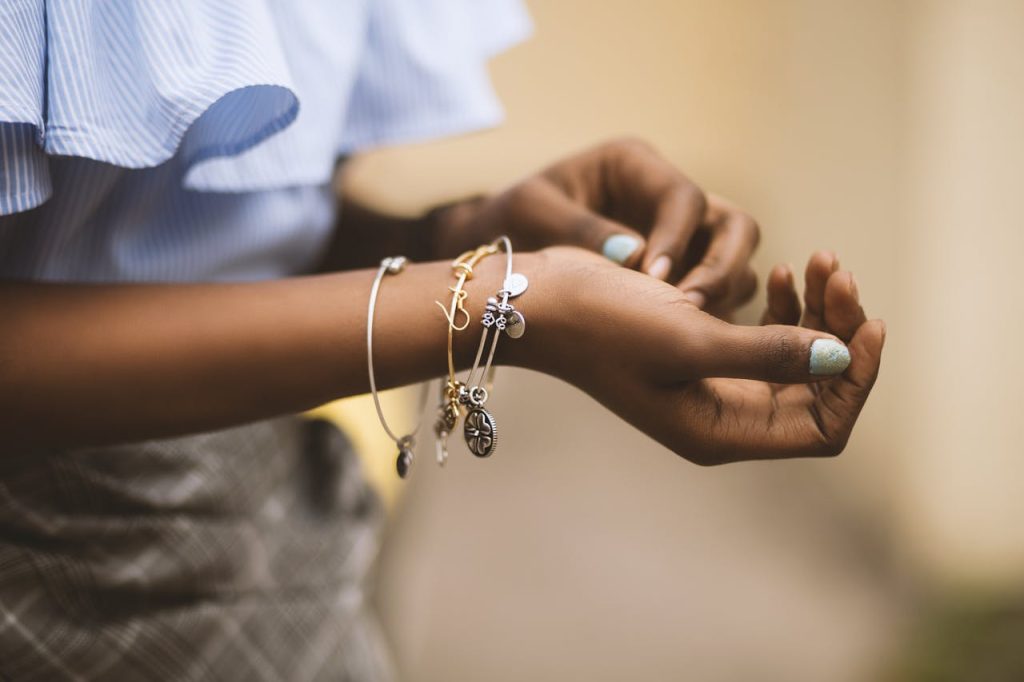 Close-up of a womans hands adorned with stylish bracelets, showcasing modern fashion jewelry.